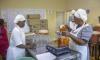 Kwithu staff packaging tomato that has been processed